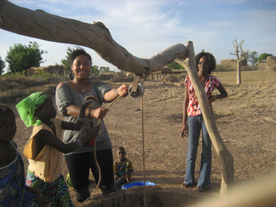 Alima  Mwemerabugabo '08 Helping Kids To Draw Water From The Village Well